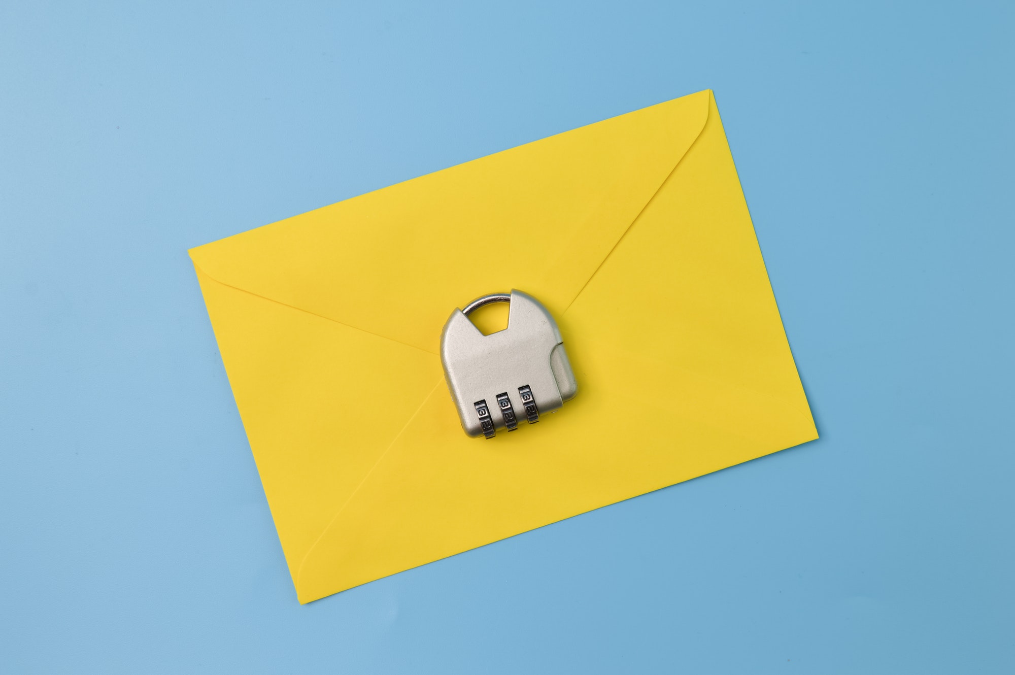 Yellow envelope and padlock isolated on a blue background