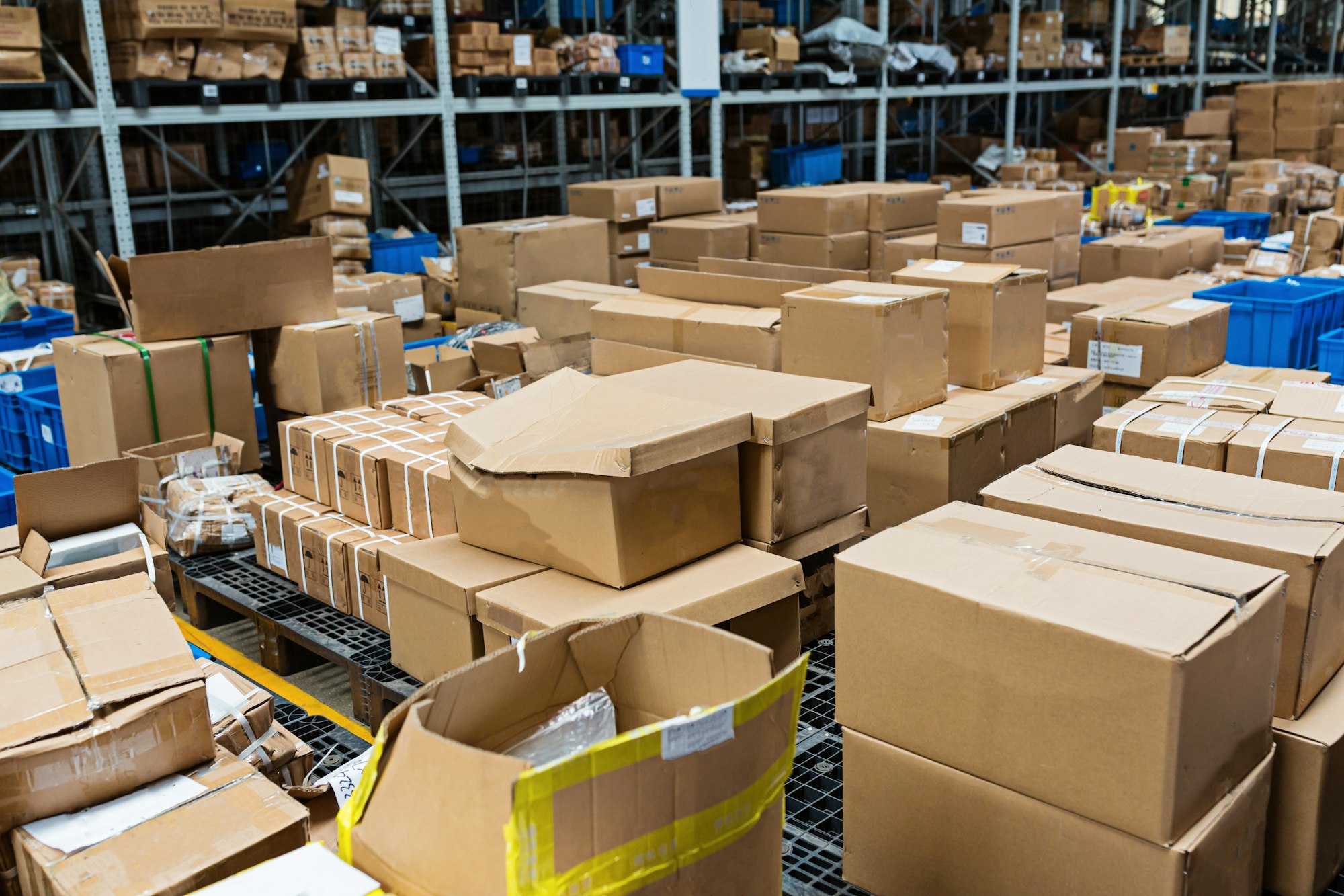 Boxes with goods lying in modern warehouse