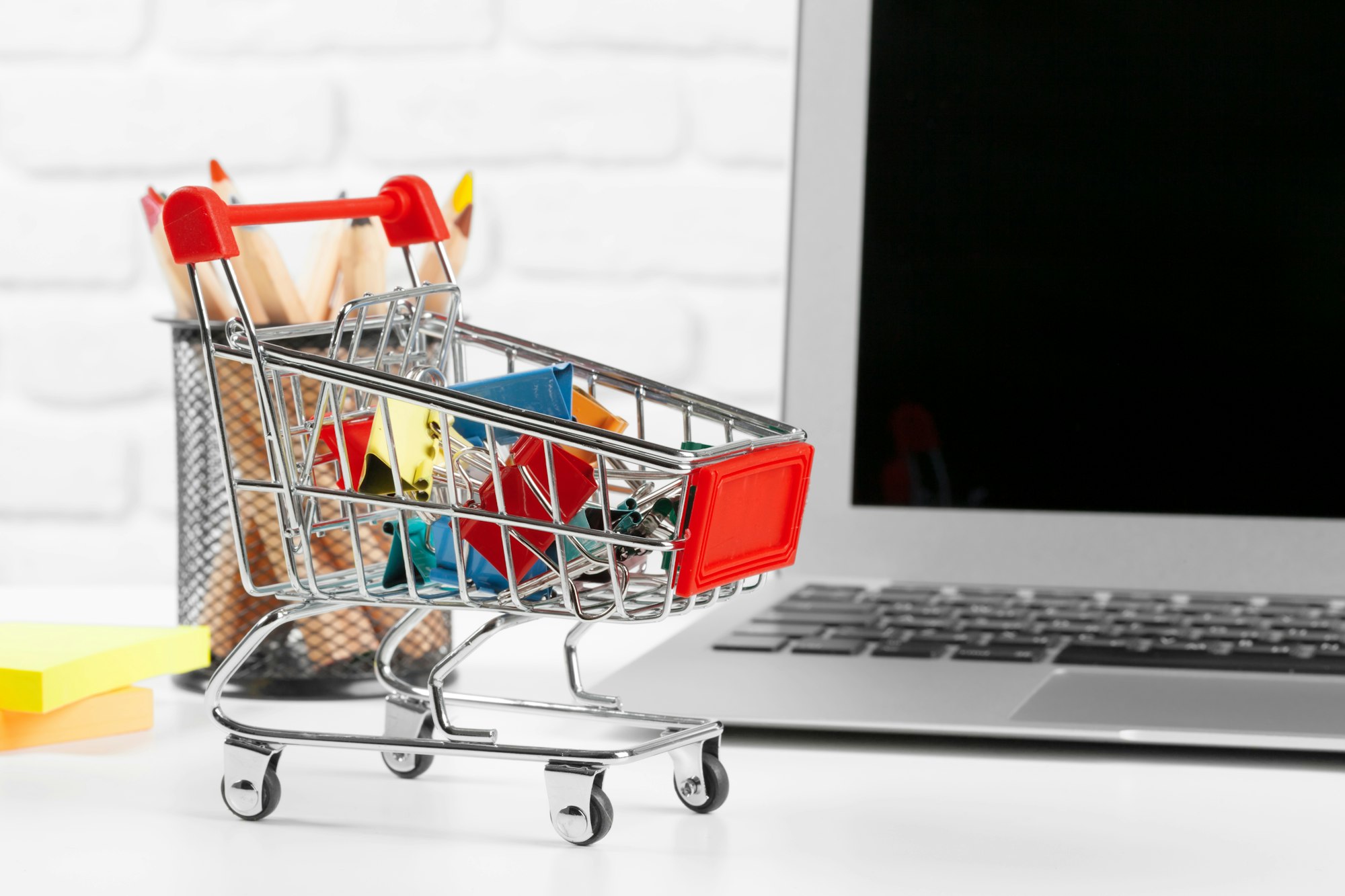 Shopping Online Concept : Mini Shopping Cart and Laptop